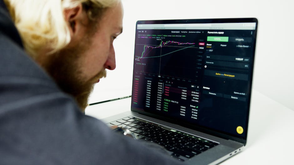 An image of a person analyzing forex trading data on a computer screen.